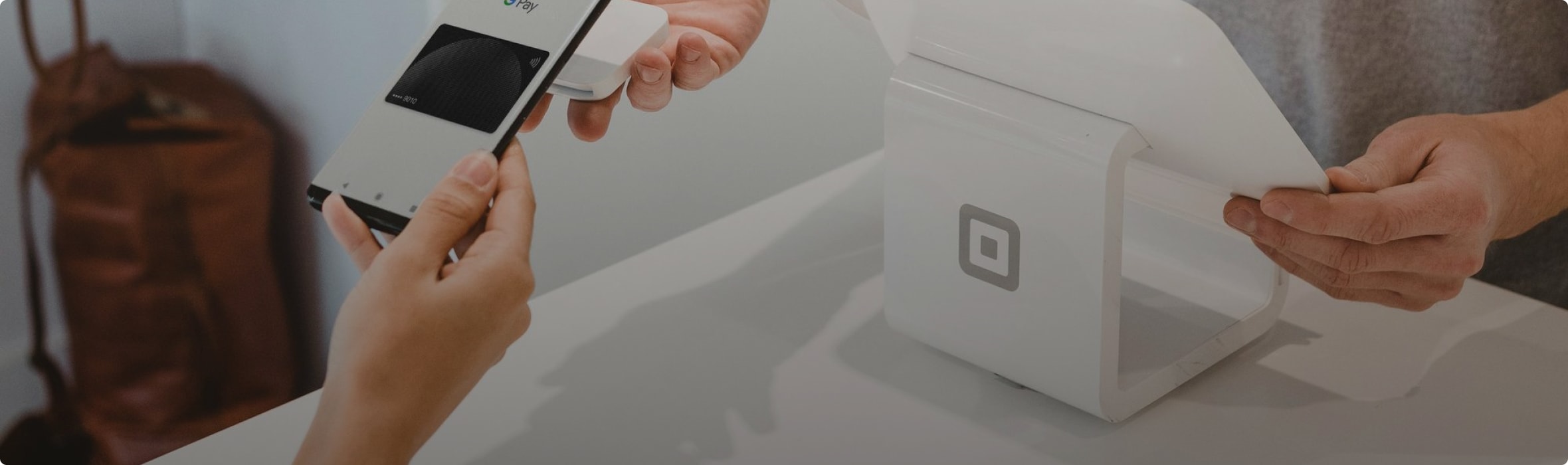 Person using an eSIM-enabled POS device to make a secure payment in a retail store.