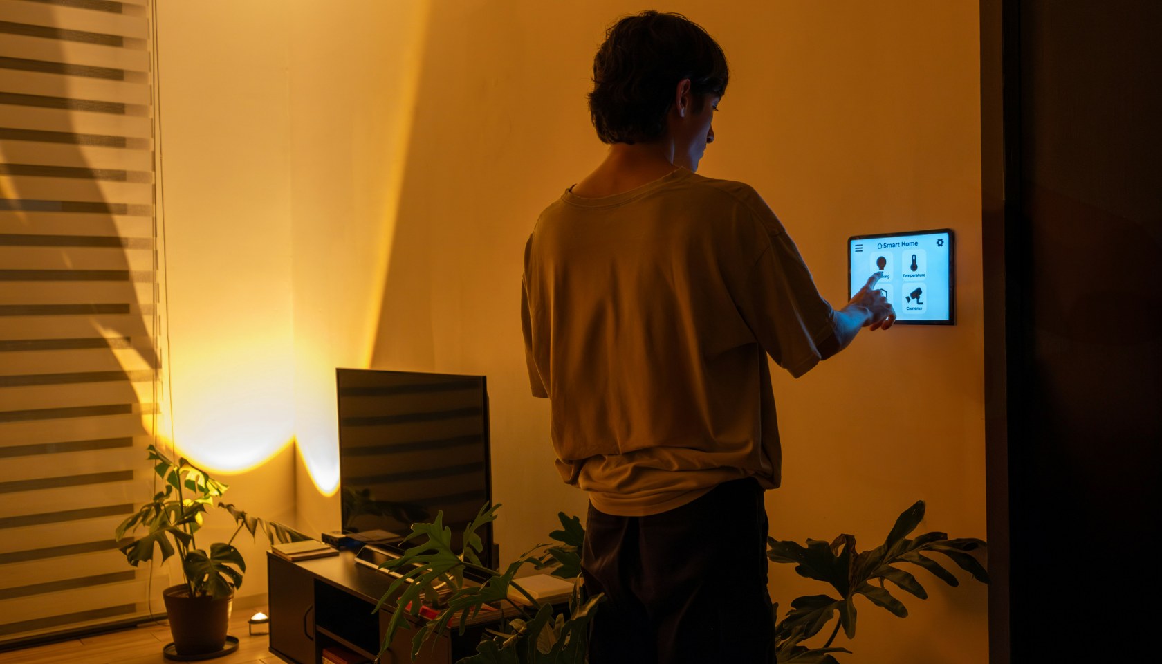 Speaker on stage at the HUB Innovation Stage during MWC Las Vegas 2024, with audience attending the eSIM Summit session and large tech displays in the background